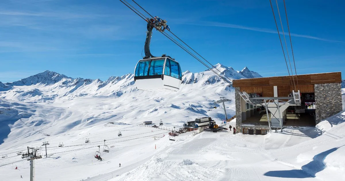 Cable car system operating over snow-covered mountain terrain