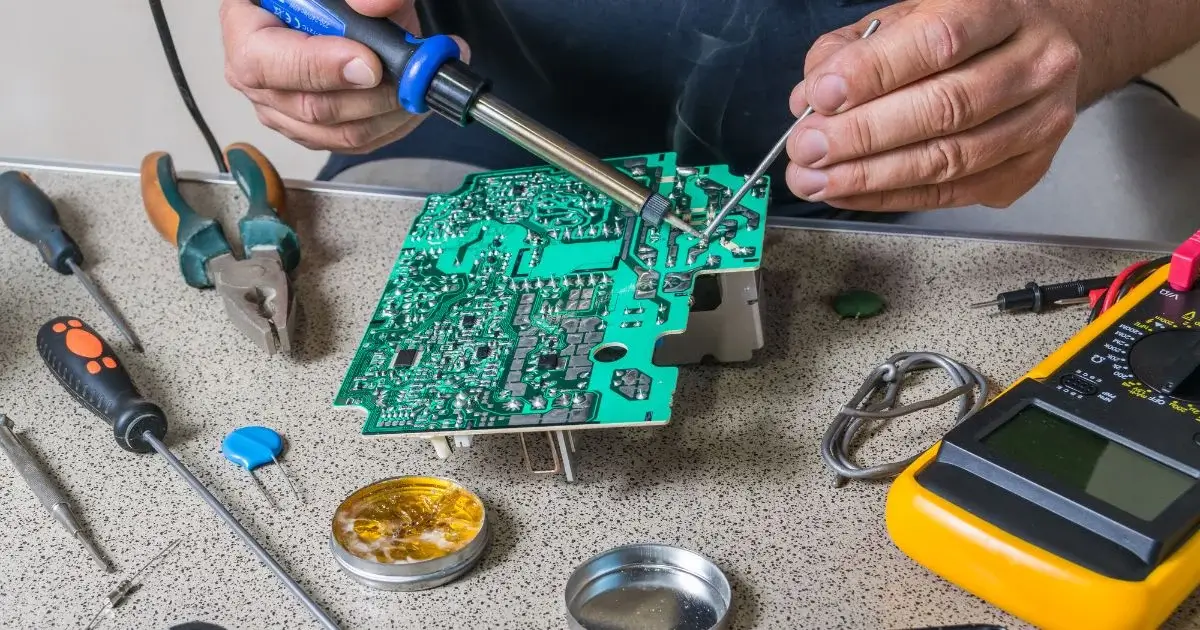 Technician repairing an electronic circuit board
